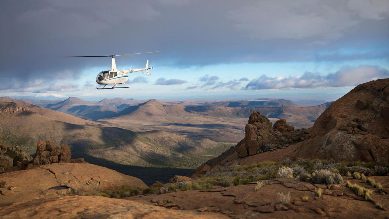 Drostdy Hotel Graaff Reinet Exterior photo A Robinson R44 helicopter flying over the Namib Desert