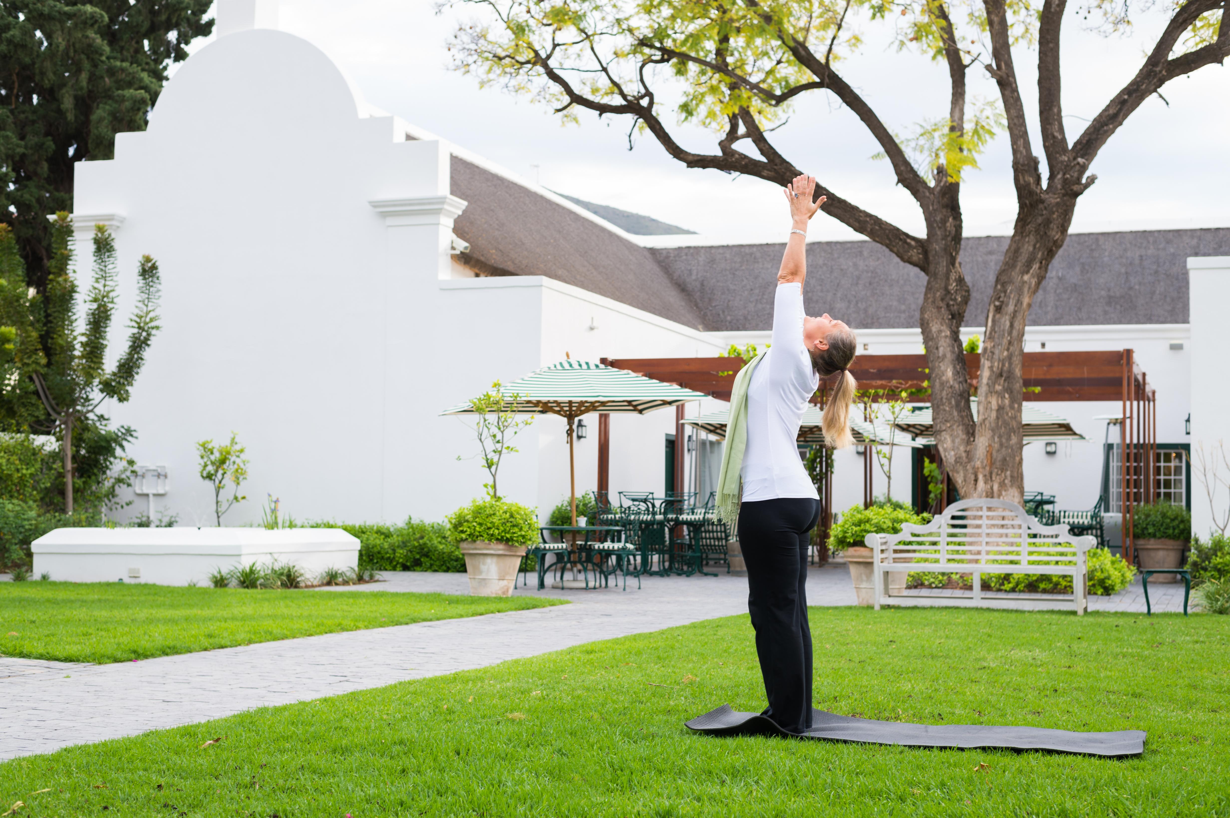Drostdy Hotel Graaff Reinet Exterior photo A woman practicing yoga at the Cape of Good Hope