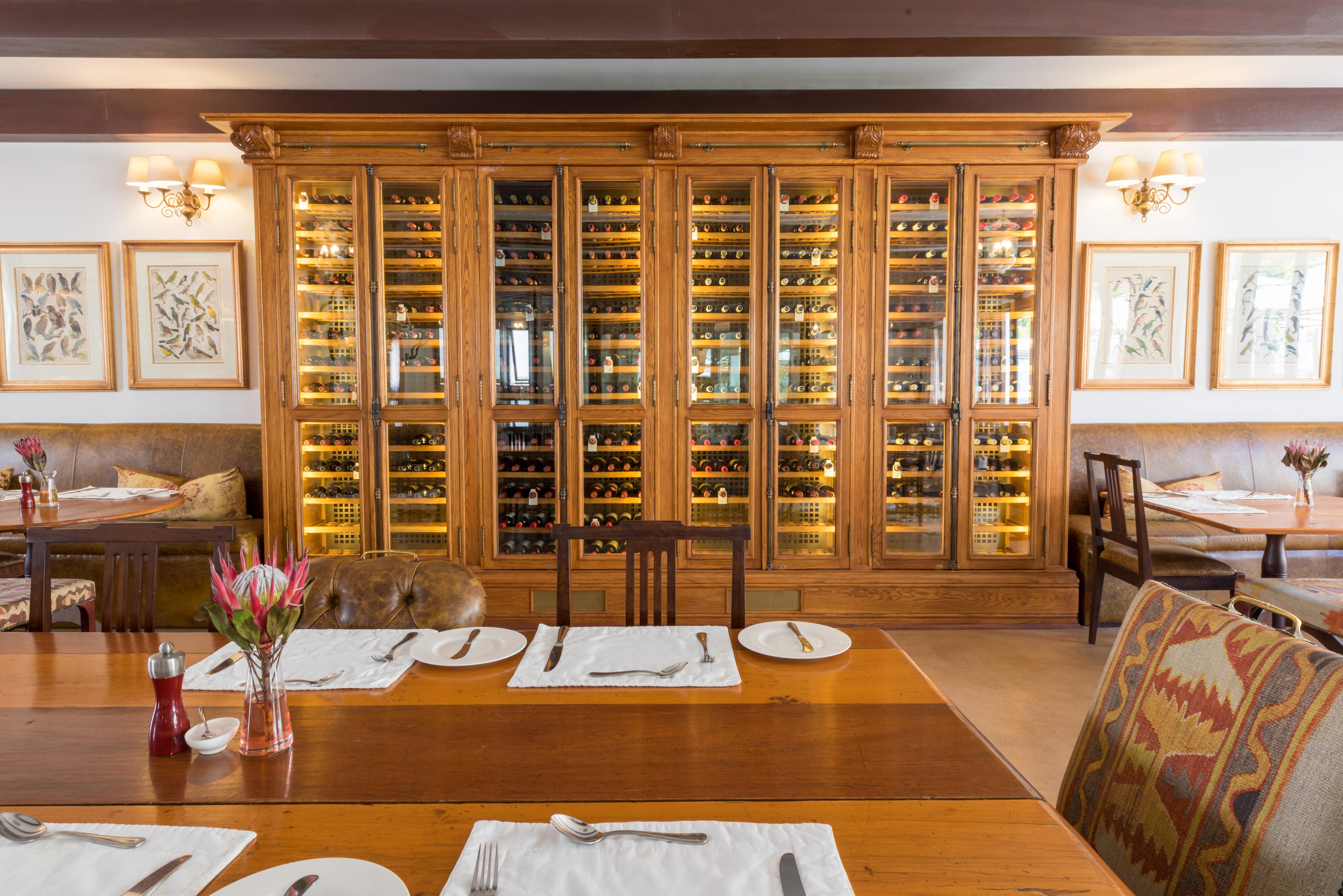 Drostdy Hotel Graaff Reinet Exterior photo Wine rack at the restaurant